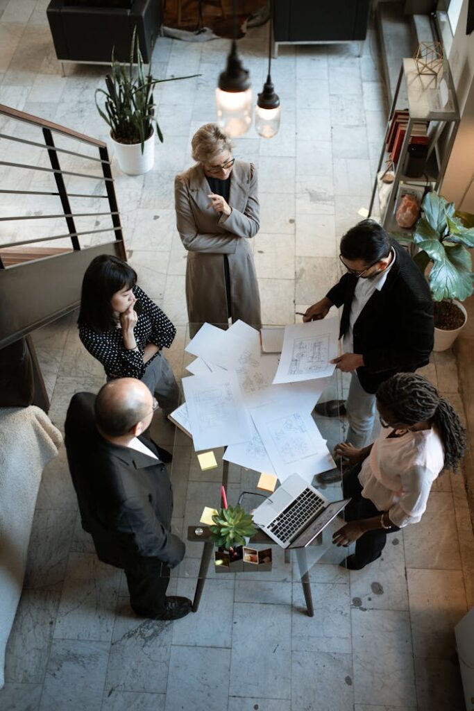 pexels-photo-5922204 A team of professionals engage in a business meeting in a sleek, modern office setting.