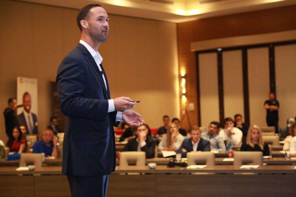 A dynamic speaker engages professionals during a business conference presentation.