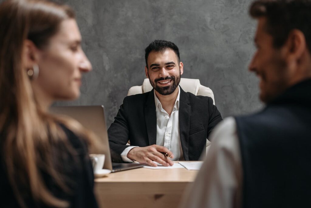 pexels-photo-8112161 Business professional meeting with clients in a modern office setting. Ideal for corporate themes.